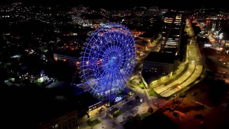 night panoramic landscape of illuminated ferris wheel at rio de janeiro brazil