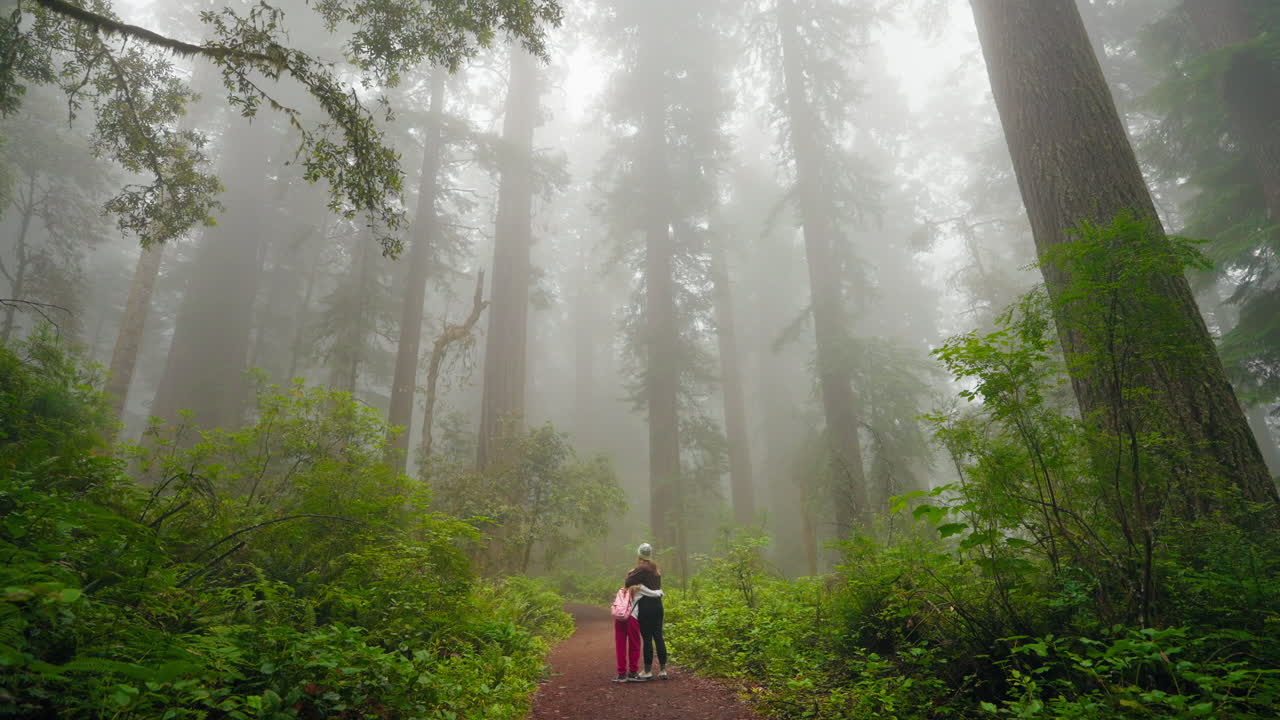 Mother and daughter embrace in love together among beauty of nature