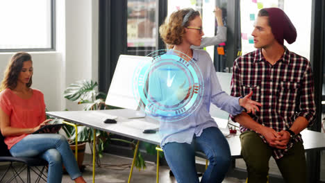 Animation-of-clock-over-caucasian-male-and-female-business-colleagues-talking-in-office