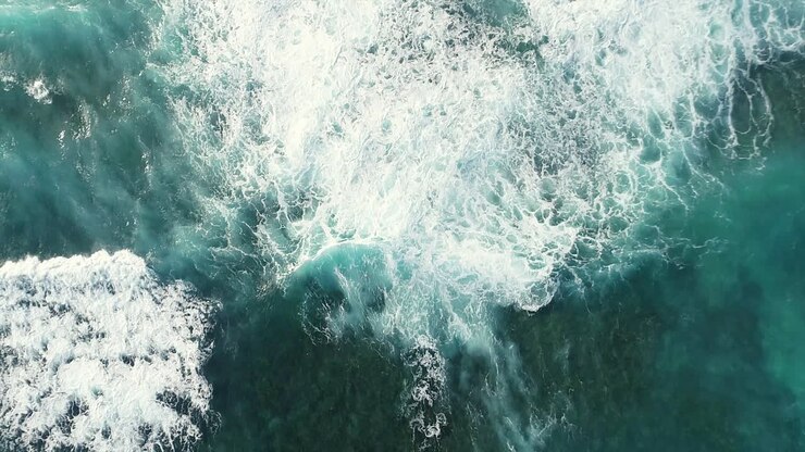Aerial top-down forward over private property along rocky coast near Najayo beach
