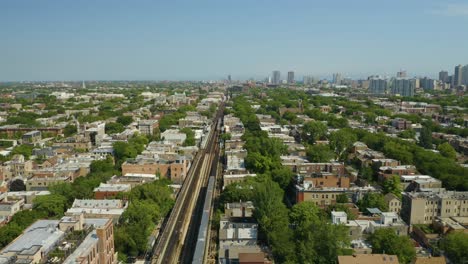 cta train approachs station on elevated tracks during summer