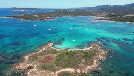 cavalli island surrounded by boats and turquoise blue sea in sardinia, italy - aerial 4k