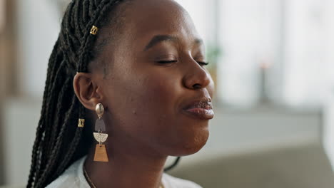 Black-woman-on-sofa,-eating-ice-cream