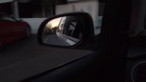 a shot of the sunset light through a rear view mirror