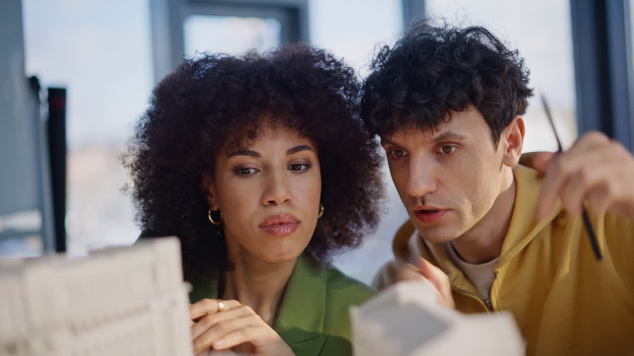 Architectural designers brainstorming project watching houses models closeup