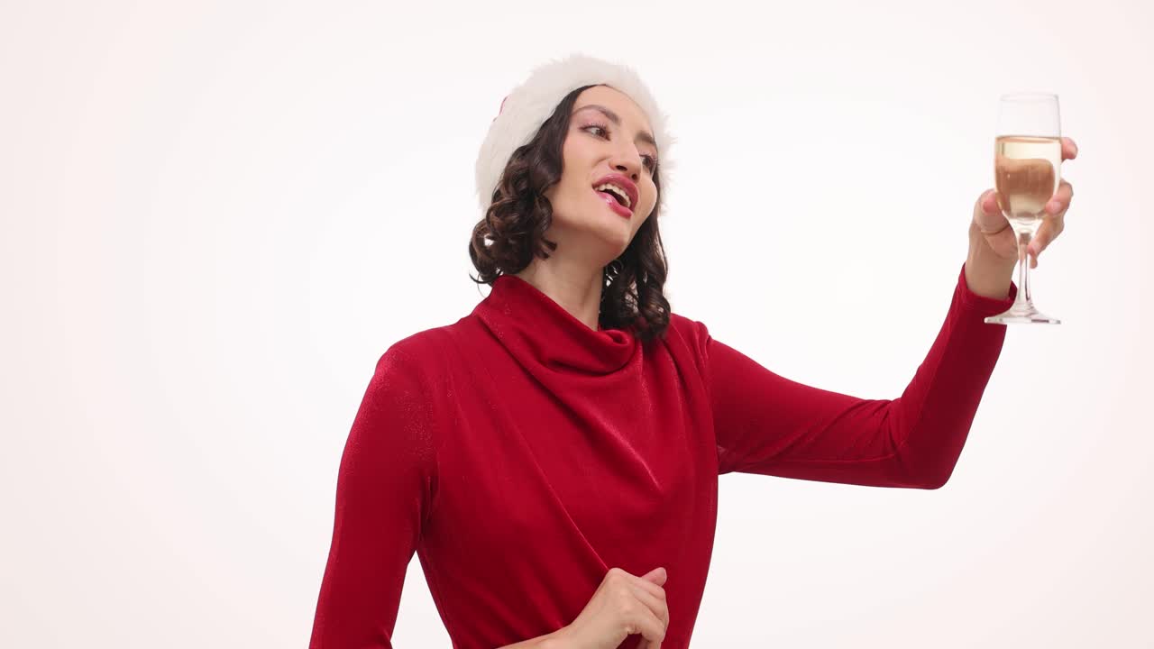 Woman in Santa hat celebrating with champagne