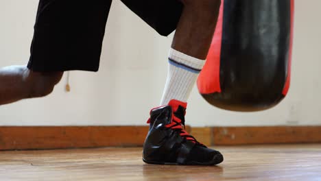 male boxer tying shoelaces in fitness studio 4k