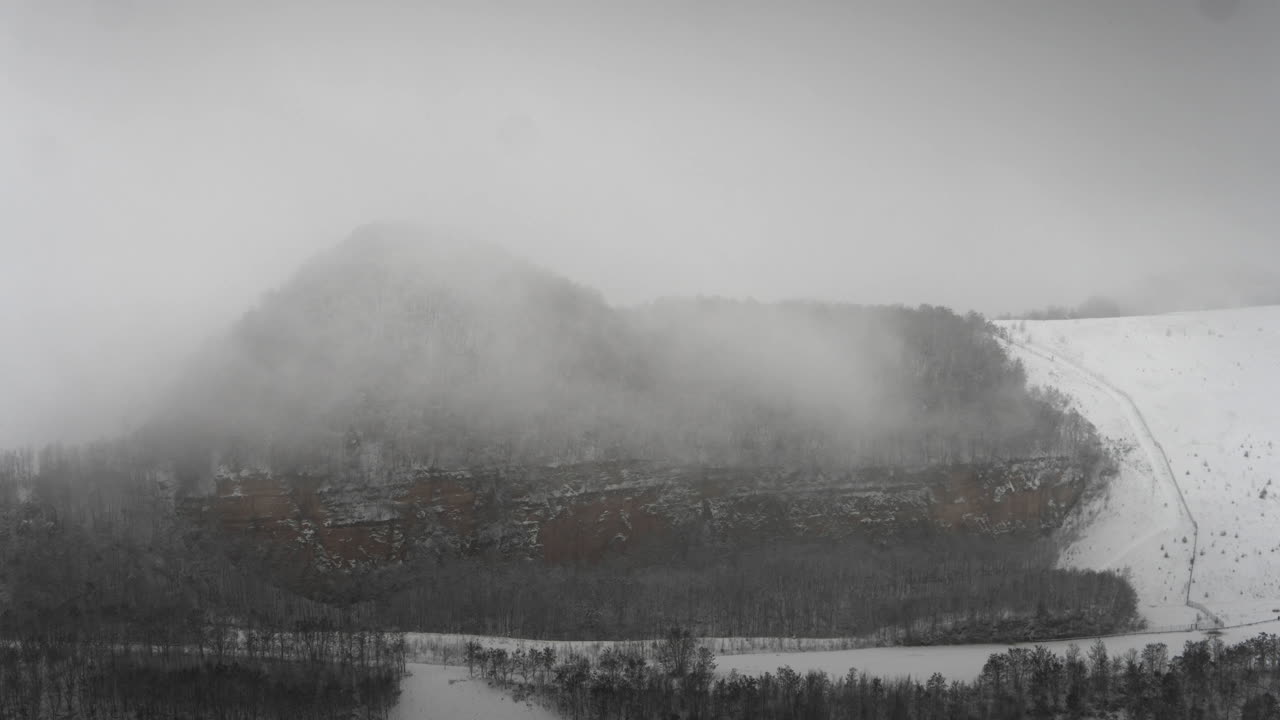 Snowy landscape. Snow covered forest, winter landscape. Fog in fast motion. Timelapse