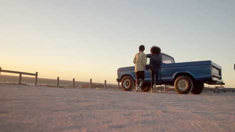 Couple-running-towards-pickup-truck-at-beach-4k