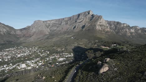 drone shot of cars driving through cape town's sprawling mountains