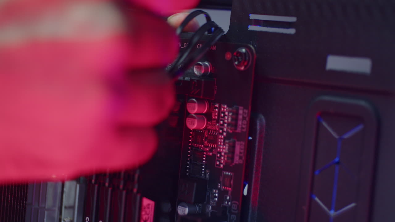 Male technician fixing calbles on a pc