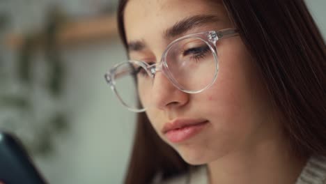 Close-up-of-caucasian-teenage-girl-browsing-phone