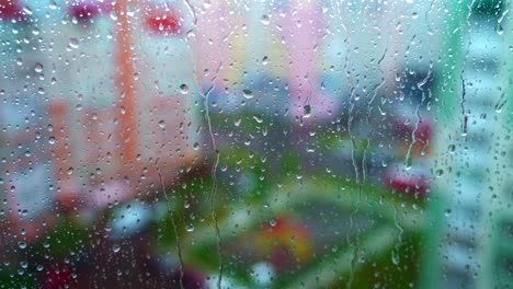 window at rainy day on blur city background. wet raindrops on window glass. abstract raindrop scenery background.