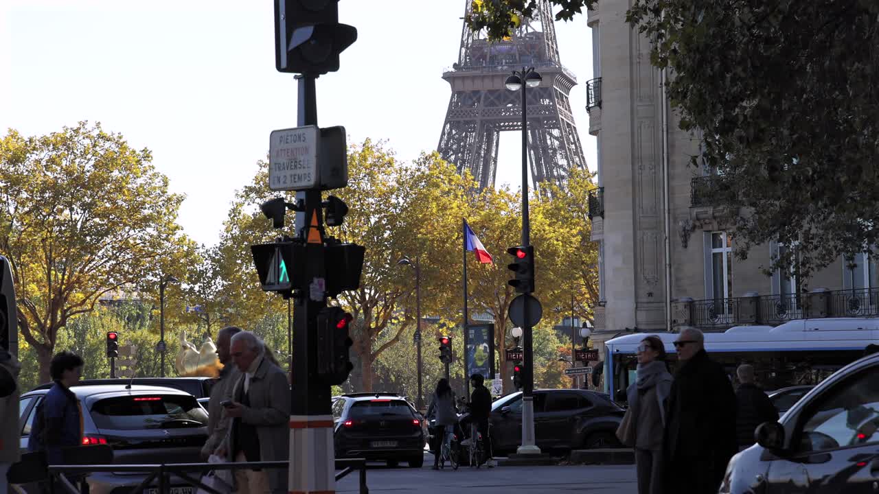 Pedestrians crossing road in front of Eiffel Tower Paris France slow-mo