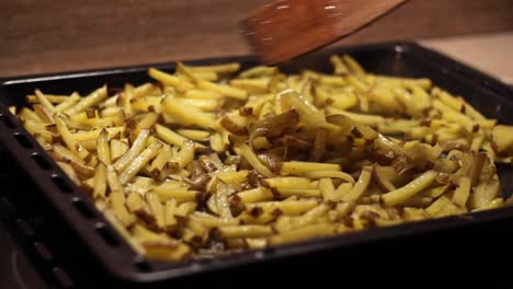 Cooking-Baked-French-Fries-hot-and-fresh-from-Oven-with-steam