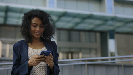 businesswoman using smartphone outdoors