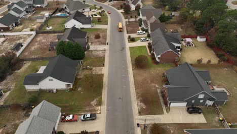 drone shot of a school bus in neighborhood