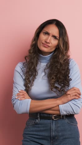 upset woman with arms crossed standing disappointed. vertical footage