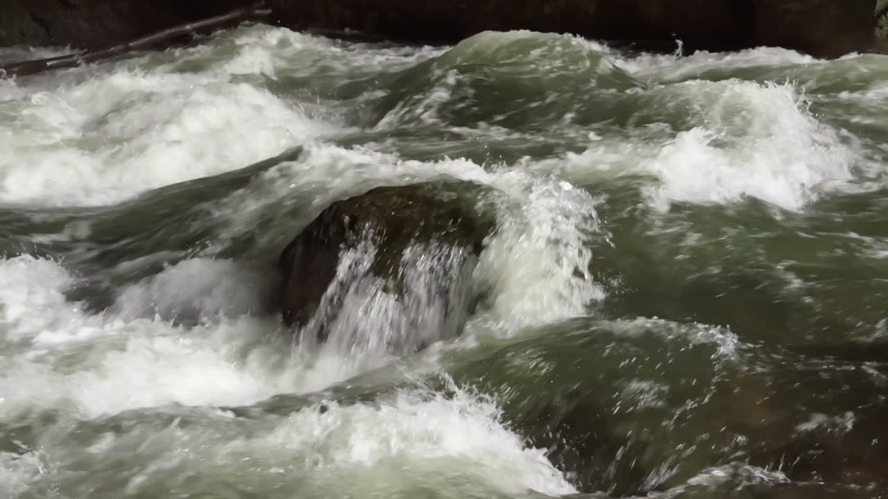 White water river rapids flowing inside Tkalca Cave, Slovenia