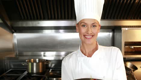 smiling chef showing a plate