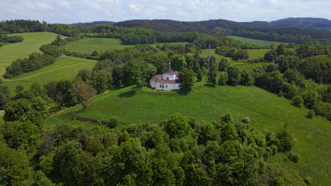 nice aerial top view flight round chapel on mountain hill, krumlov czech republic summer 2023