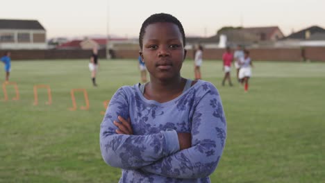 portrait of young adult female rugby player on a rugby pitch