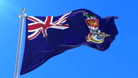 flag of the cayman islands waving at wind with blue sky, loop