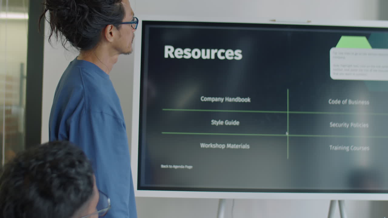 Asian Man Explaining Presentation on Digital Screen