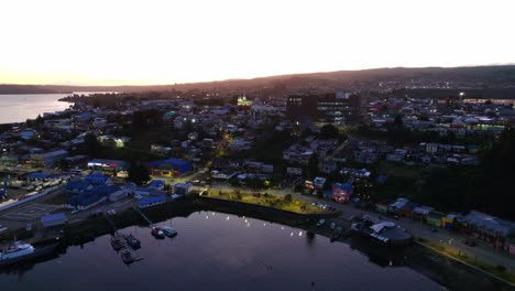 Aerial-Drone-Sunset-Travel-Landscape-of-Castro-Island-Patagonia-Chiloé,-Chilean-Travel-Destination,-Skyline-and-Delta-houses-around-Romantic-Sea-Shore