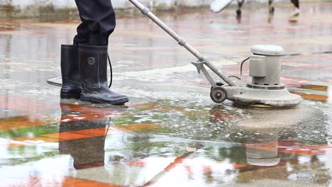 labor cleaning the floor with industrial floor cleaning machine