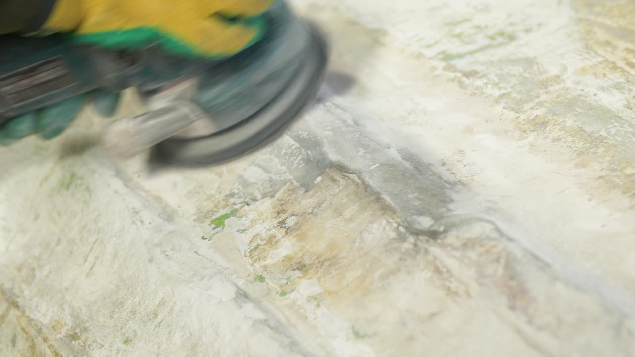 Sanding fiberglass boat hull using orbital sander