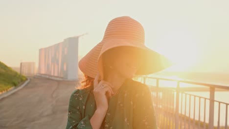 woman in a hat at sunset