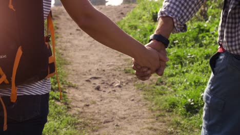 young lovely couple backpackers tourists walking holding hands toward roman aqueduct arches in parco degli acquedotti park ruins in rome on romantic misty sunrise with guitar and sleeping bag slow motion