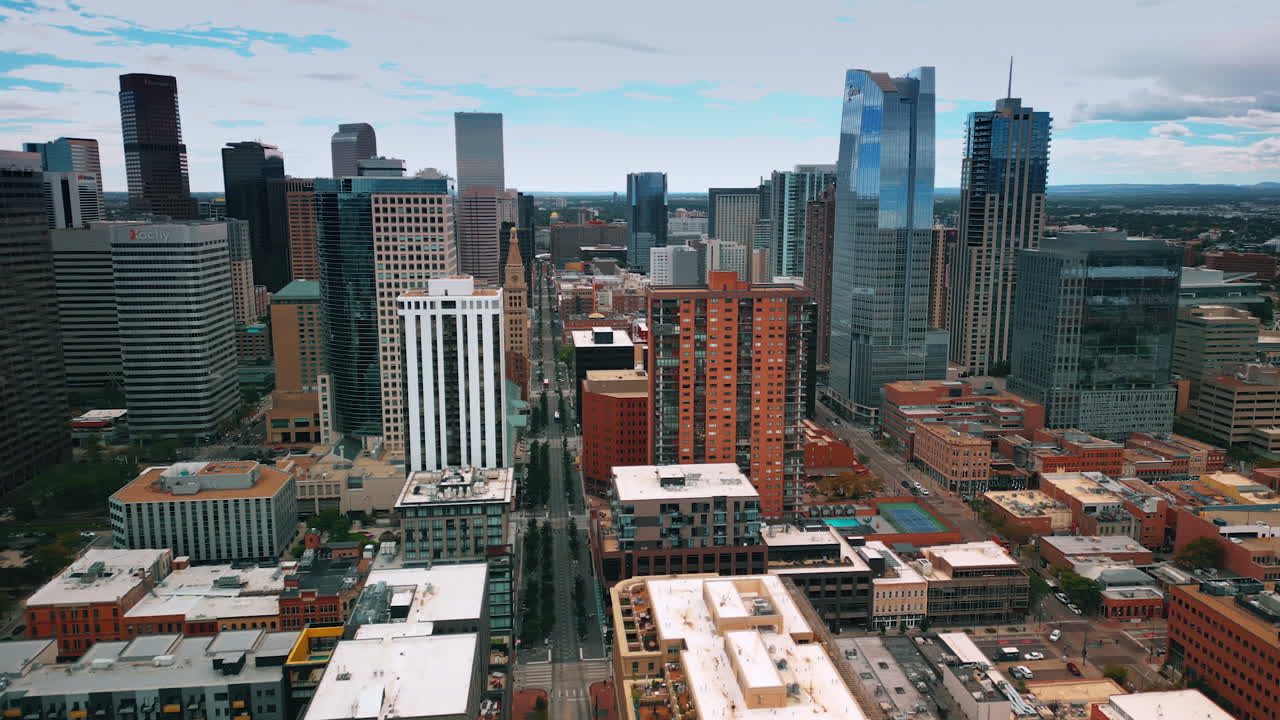 Denver, USA, 28 July 2025: Beautiful scenery of downtown with high-rises of diverse design. Drone flight over the midtown of Denver, Colorado, USA on gloomy day