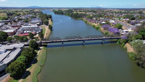 puente kempsey a través del río macleay con vista de los árboles de jacaranda y el centro comercial en nsw, australia