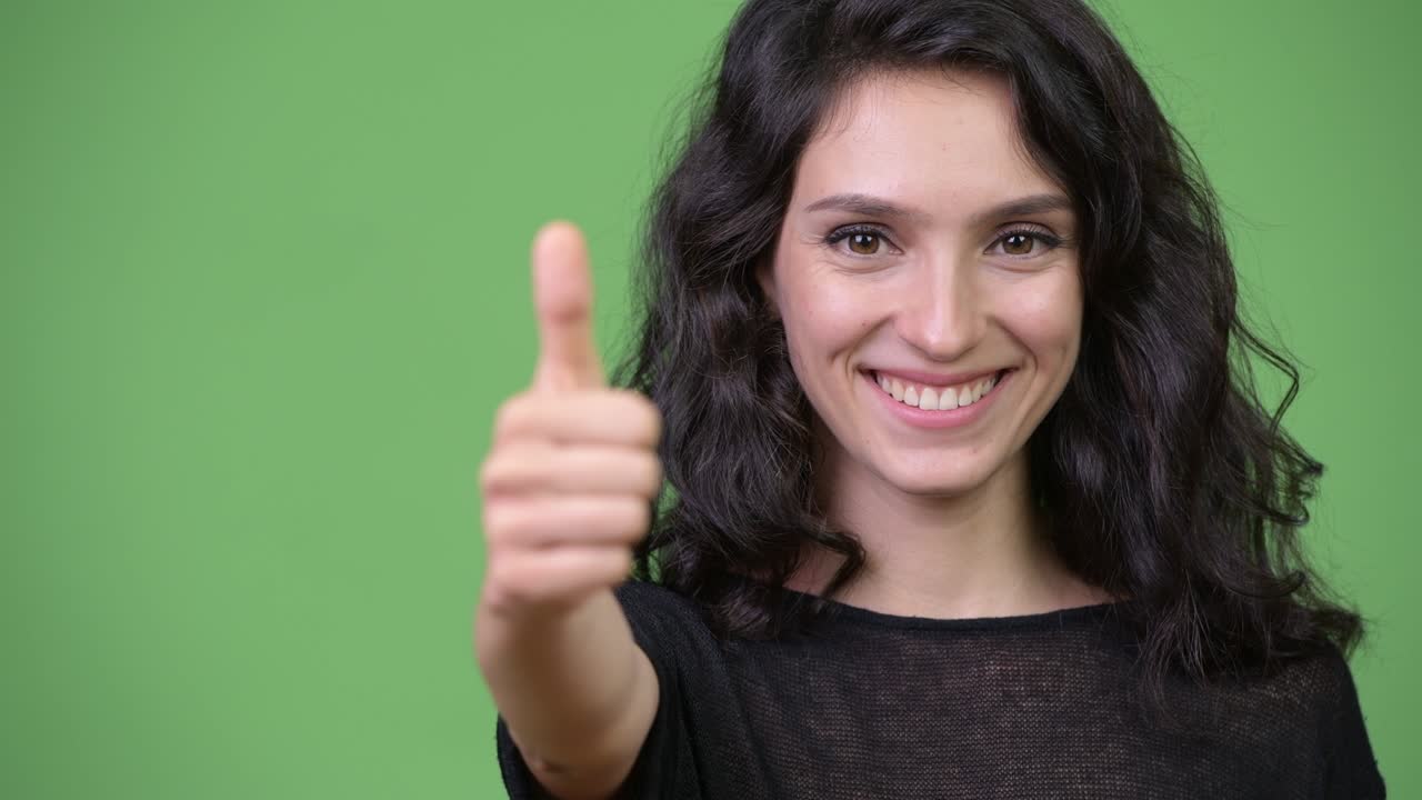 Young beautiful woman giving thumbs up