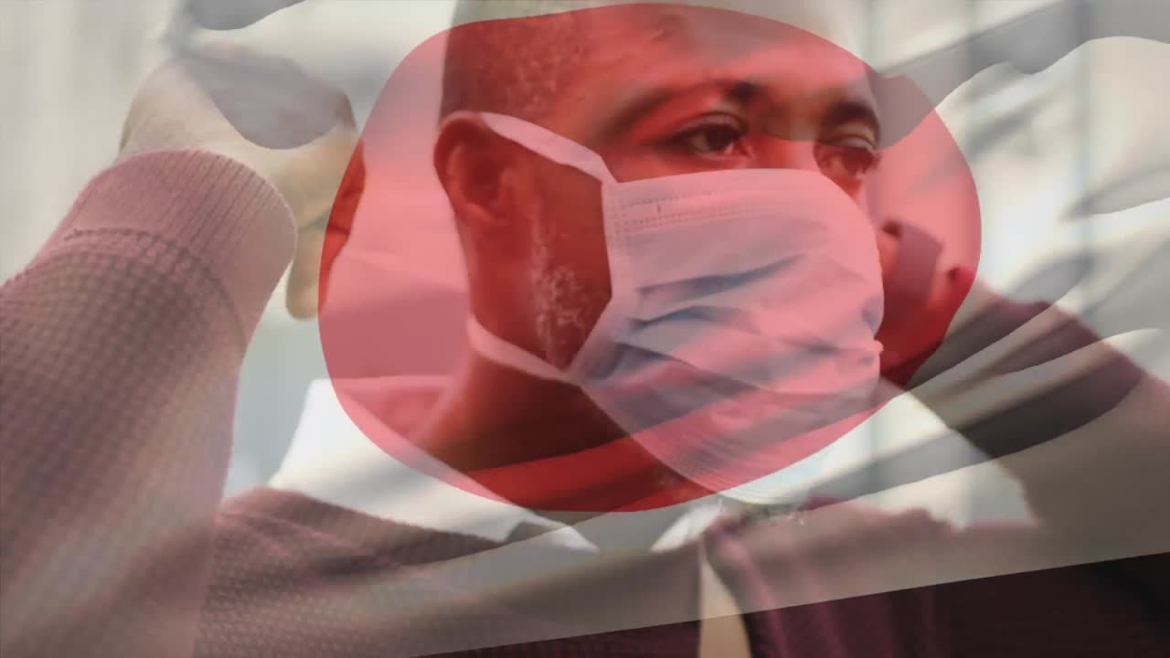 코로나 19 대유행 기간 동안 얼굴 마스크를 쓴 남자가 일본 국기를 흔들고 있는 애니메이션