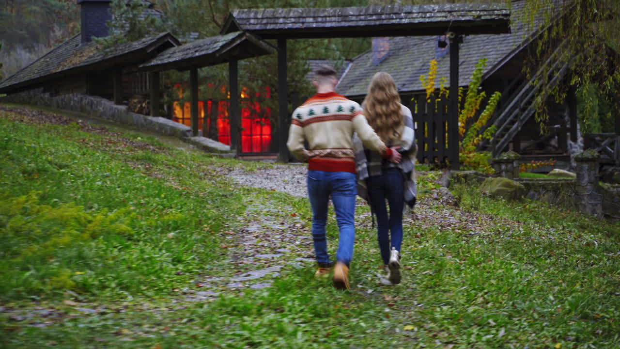 Romantic couple walk outside hugging each other. Autumn nature background. View from the back. Love story video.