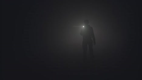 person walking with a flashlight in the fog