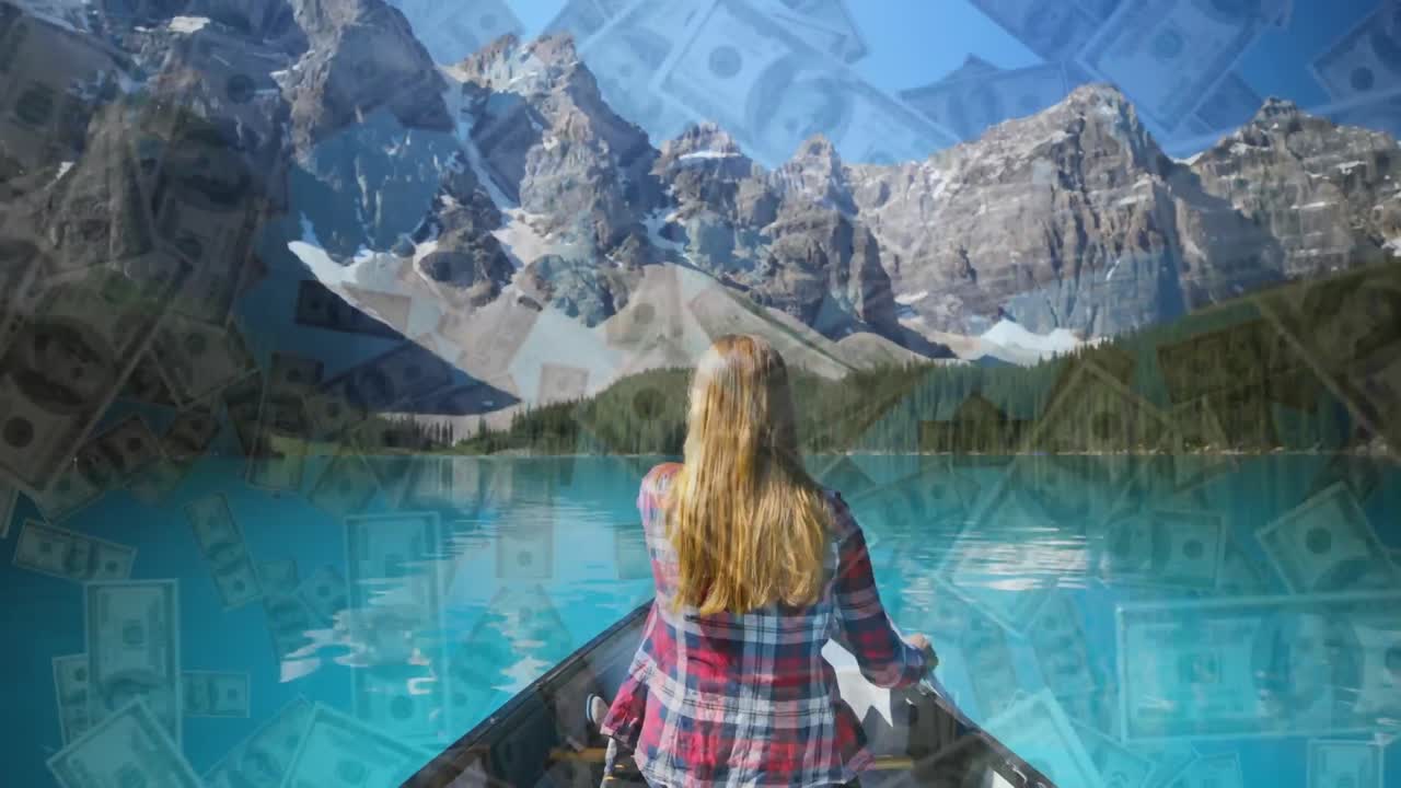 vista trasera de una mujer navegando en un lago contra billetes de dólar estadounidense cayendo