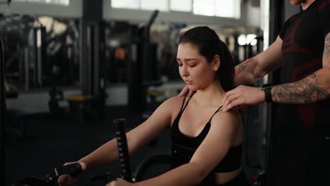 woman doing a workout with her personal trainer at the gym.