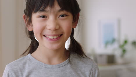 portrait of happy little asian girl smiling playfully having fun positive childhood 4k footage