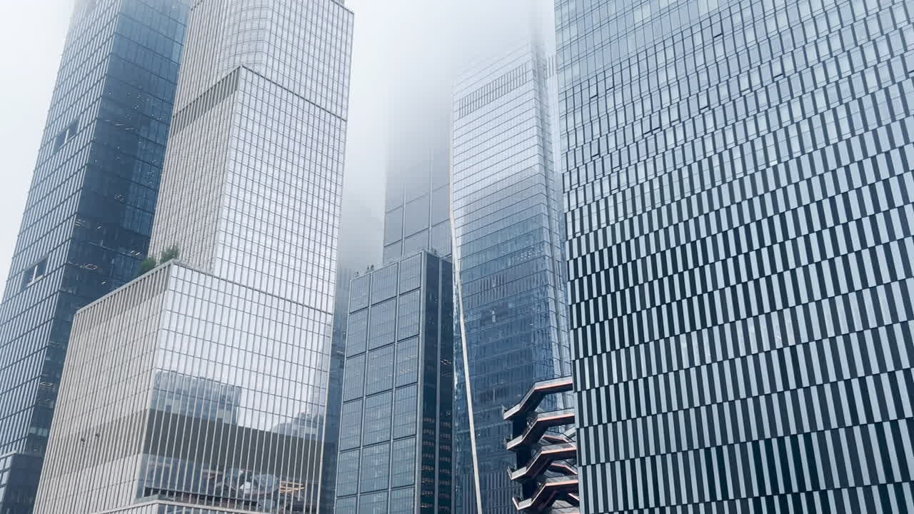 Modern skyscrapers rising in Manhattan fog