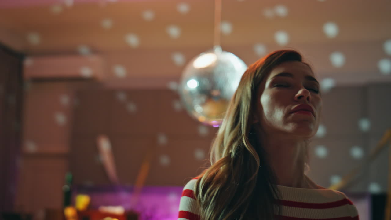 Woman relaxing party lights closing eyes close up. Calm beautiful girl dancing