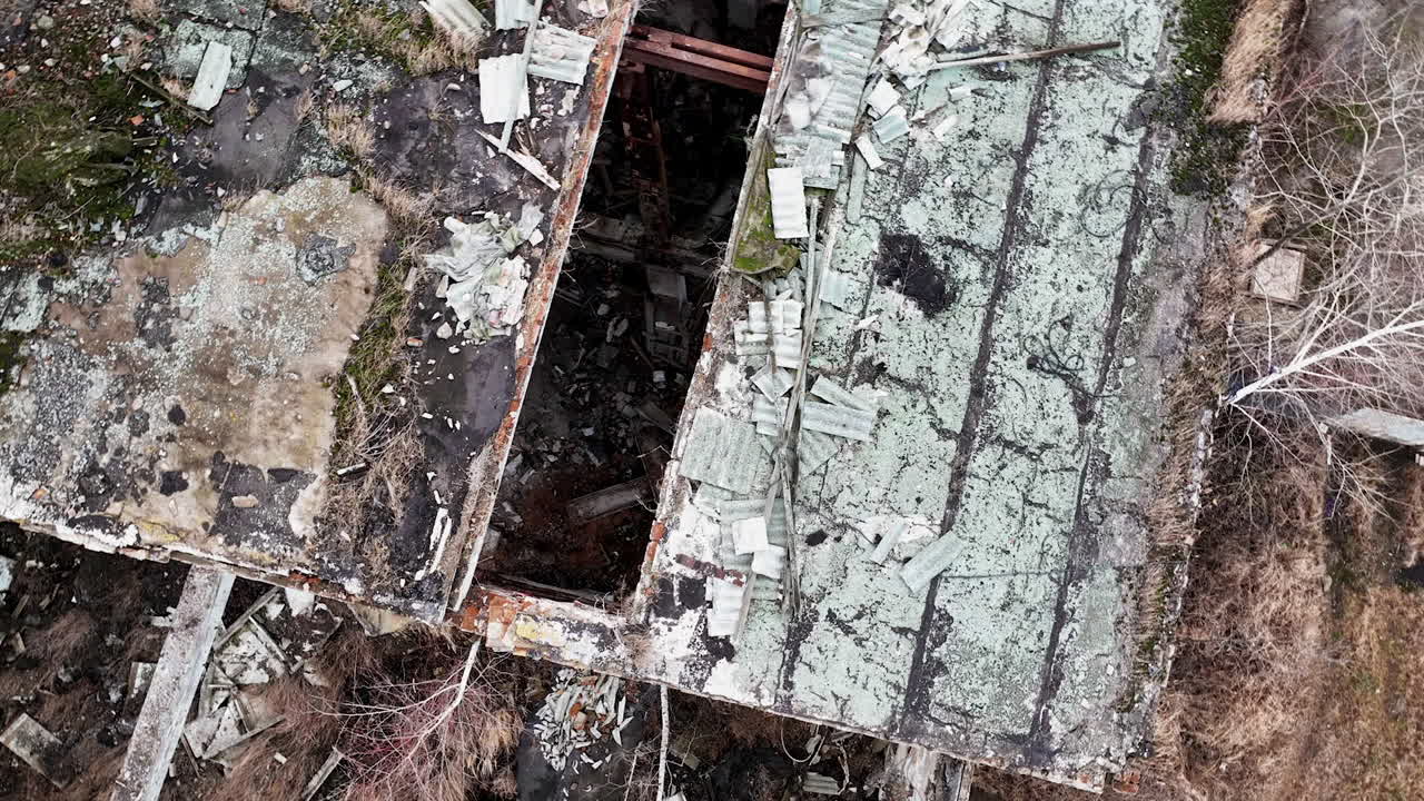 Debris left from an old industrial plant. Top aerial view of destroyed factory. Circle movement around the place.