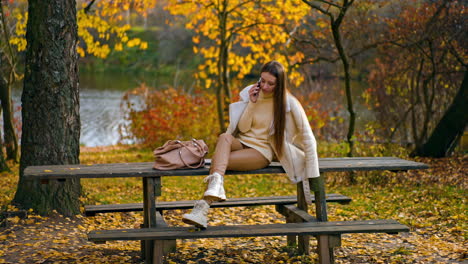 woman talking on phone in autumn park
