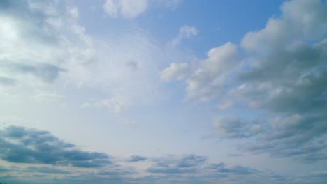 beautiful big and fluffy clouds motion at sunny day in blue sky. white clouds floating in the blue sky. time lapse.