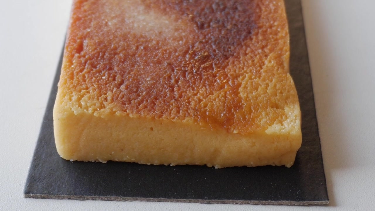 Caramelized Turron Yema on a dark slate evokes sweetness and indulgence