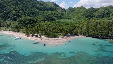 Aerial-arc-of-tourist-boats-anchored-off-pristine-Playa-Ermitano-in-Caribbean