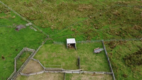 flying upwards for a birdseye view of a sheep yard on a new zealand farm